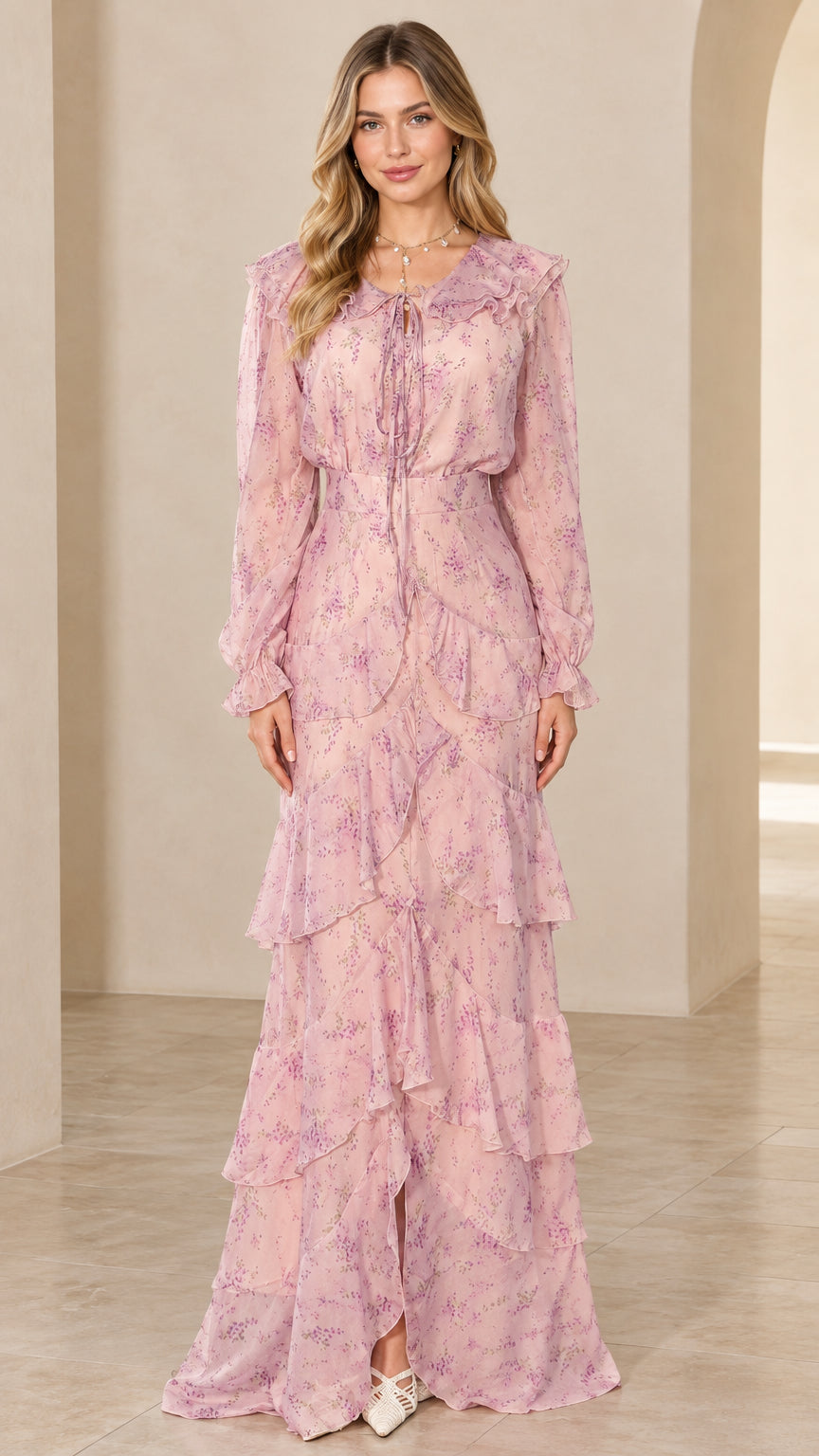 Front view of model wearing a long sleeve blush pink floral tiered maxi dress