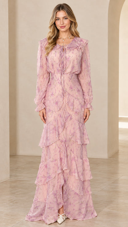 Front view of model wearing a long sleeve blush pink floral tiered maxi dress