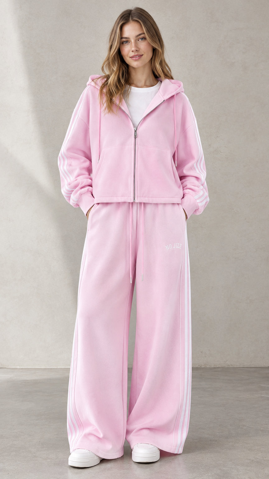 Front view of woman wearing Light Pink zip-up hoodie and wide-leg tracksuit set