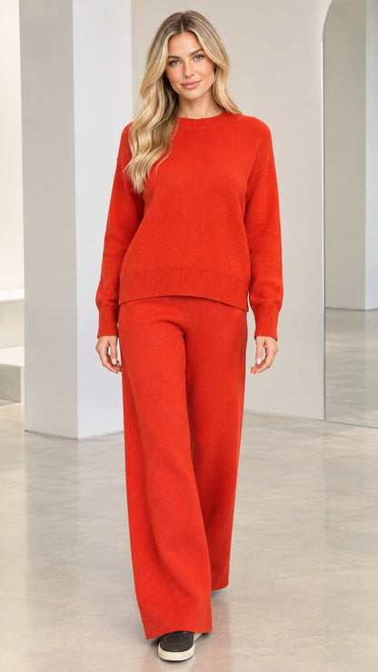 Front view of model wearing rust red knit sweater and matching wide-leg pants set