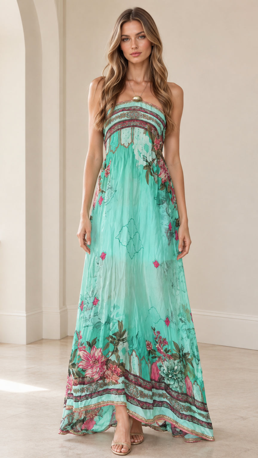 Front view of woman wearing turquoise strapless floral maxi dress with embellished neckline