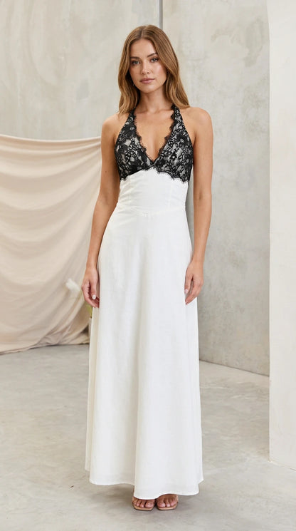 Model wearing white halter maxi dress with black eyelash lace bodice front view