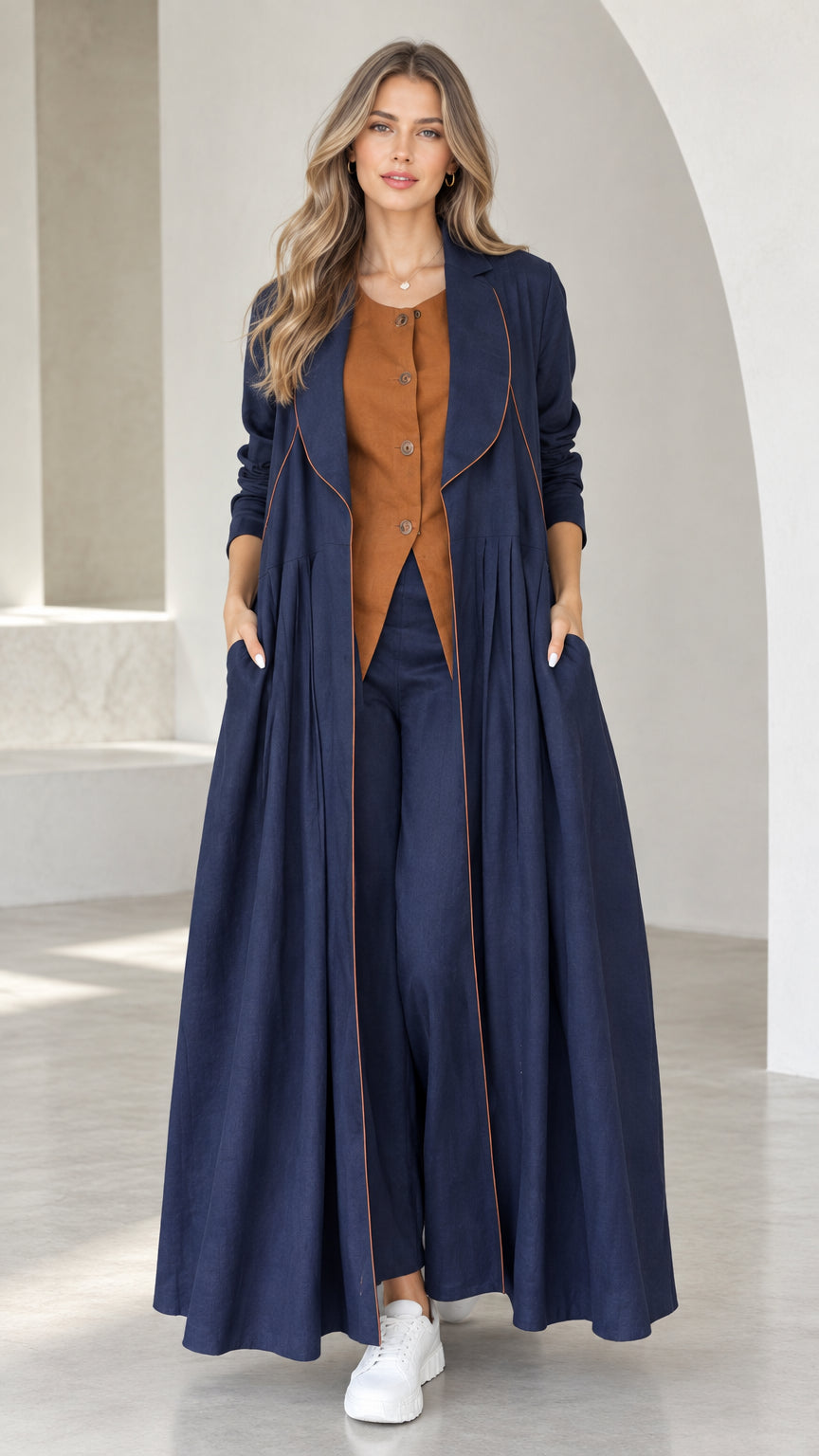 Front view of model wearing Navy Blue pleated maxi duster coat