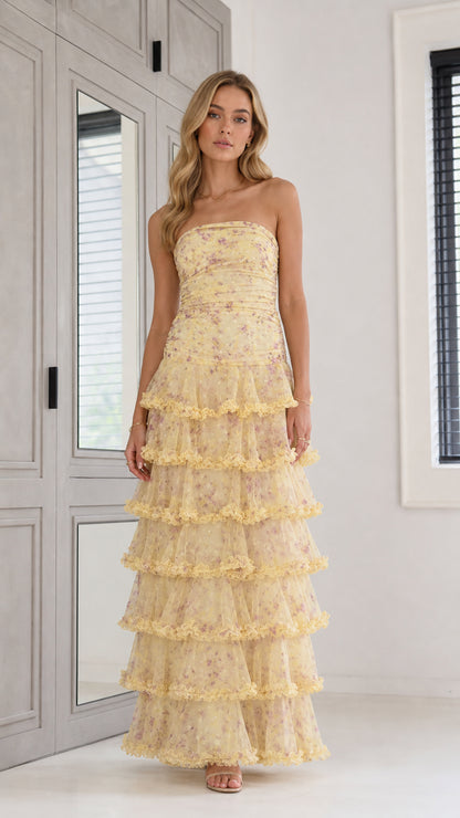 Front view of yellow strapless tiered floral maxi dress