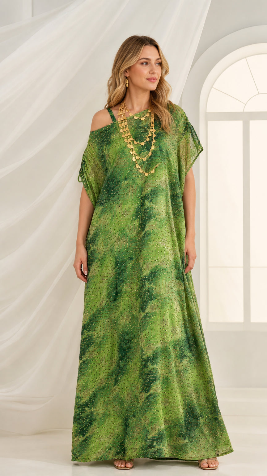Front view of green abstract print cold-shoulder kaftan maxi dress with layered gold necklace