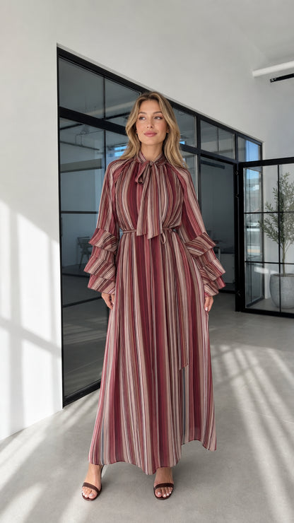 Model wearing burgundy striped ruffle sleeve maxi dress front view