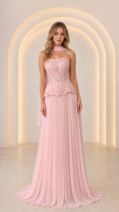 Front view of model wearing Blush Pink strapless lace peplum evening gown with pleated skirt and matching scarf