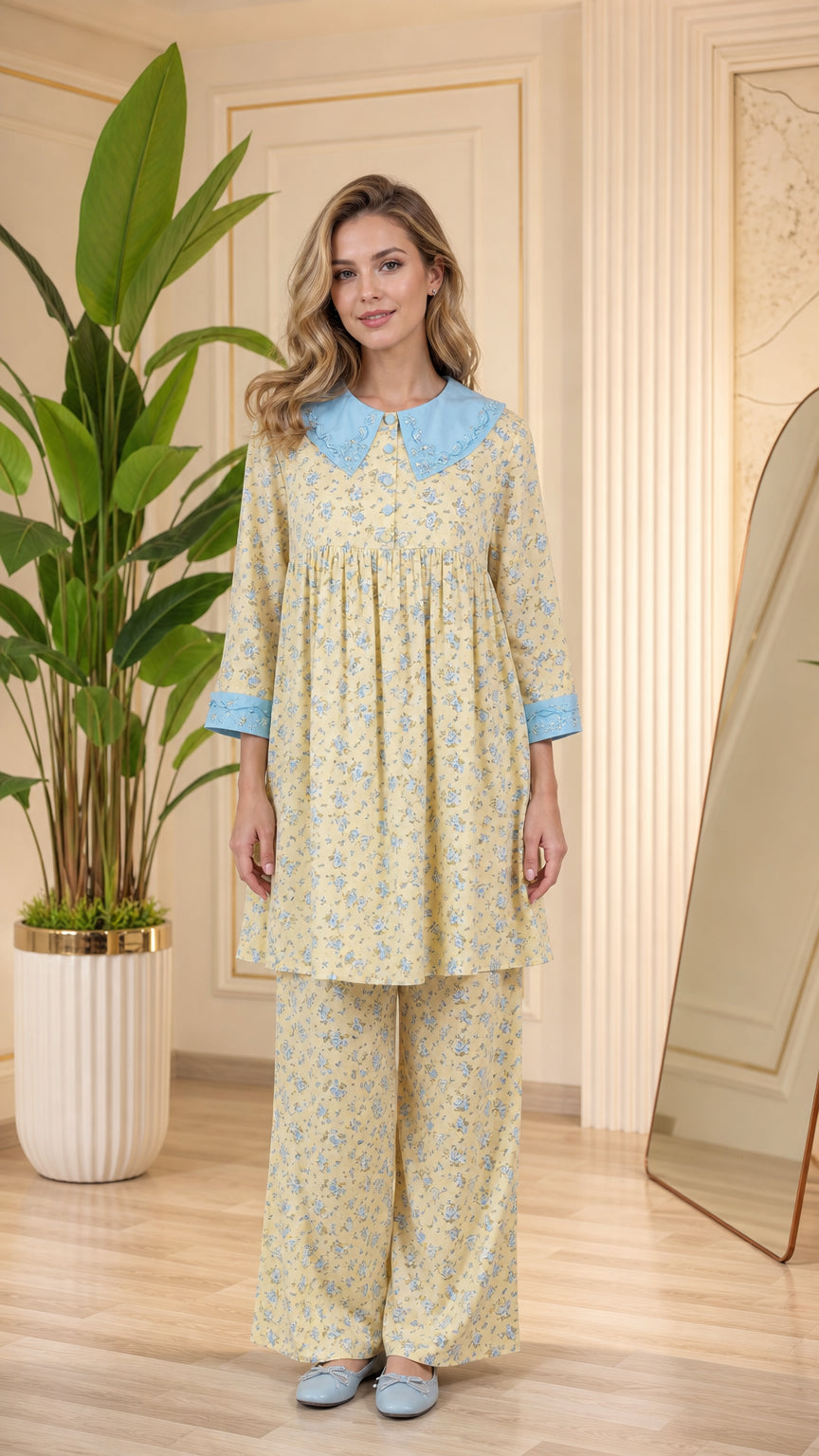 Front full-length view of model wearing pastel yellow floral pajama set with light blue Peter Pan collar