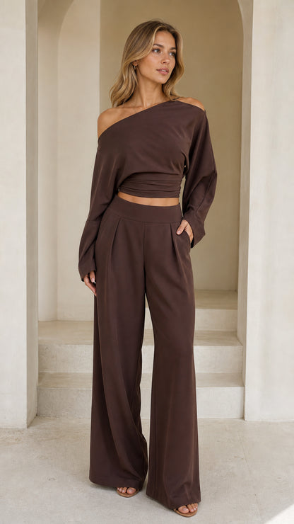 Full front view of model wearing chocolate brown off-shoulder crop top and wide-leg pant set