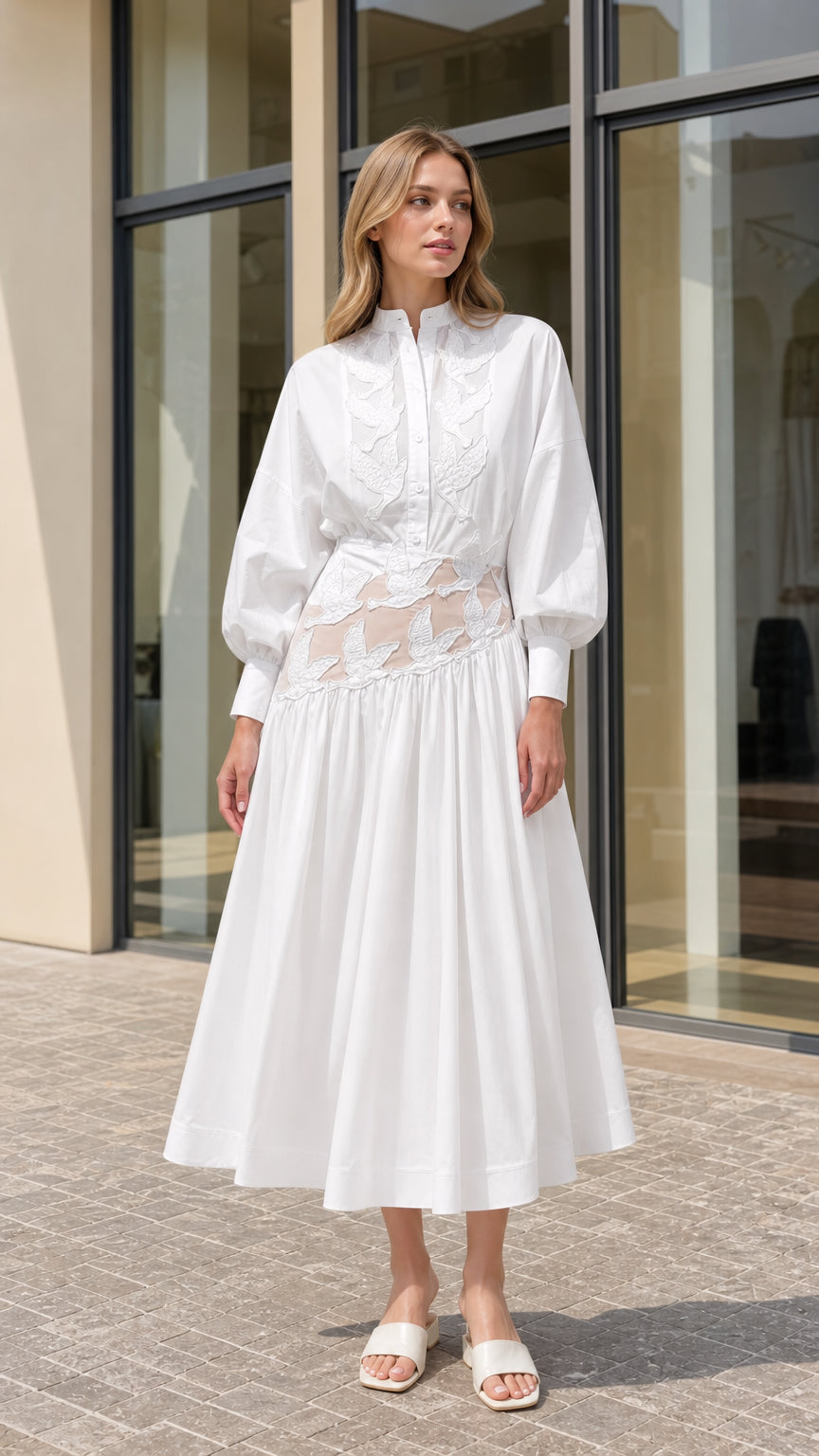 Front view of model wearing white embroidered sheer cutout midi shirt dress