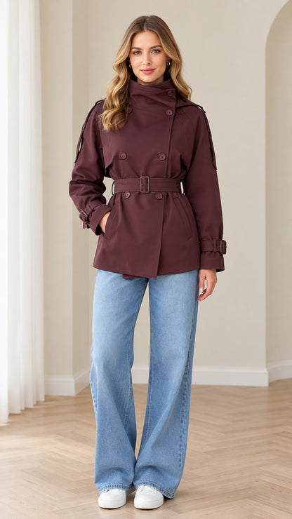 Front view of model wearing burgundy double-breasted short trench coat with belt