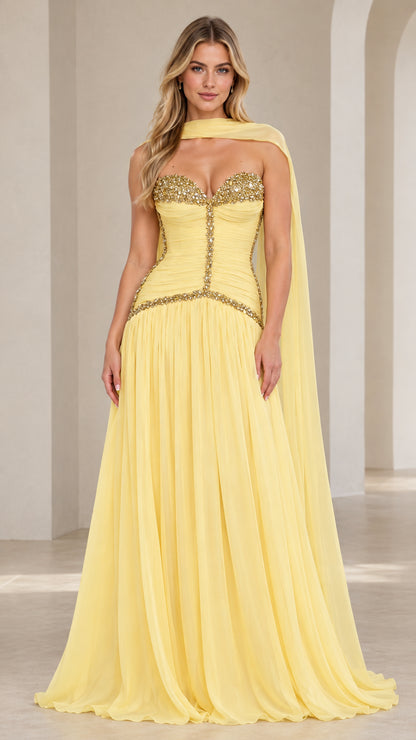 Front view of model wearing pastel yellow strapless embellished corset chiffon evening gown with matching scarf