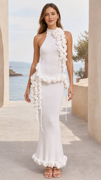 Front view of woman wearing white halter ribbed knit maxi dress with 3D pom pom trim