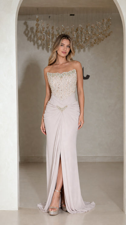 Front view of model wearing strapless silver lilac beaded evening gown with front slit