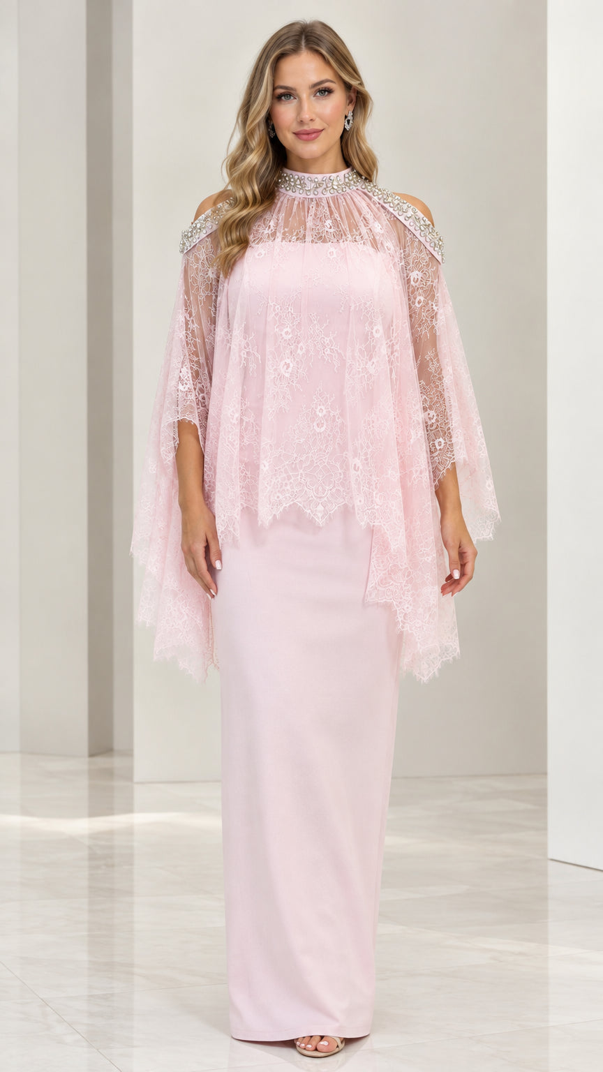 Front view of woman wearing blush pink beaded lace capelet column maxi gown