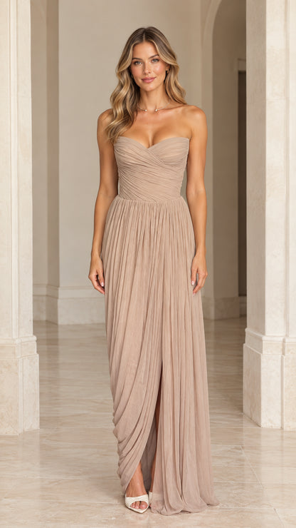Front view of model wearing a taupe strapless pleated sweetheart corset maxi dress