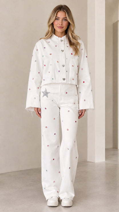 Front full view of woman wearing white rhinestone embellished cropped jacket and matching wide-leg pants