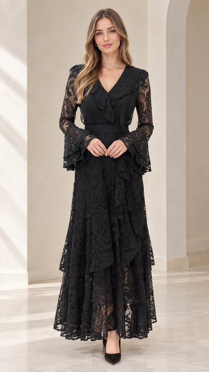 Front full view of woman wearing black tiered floral lace maxi dress with bell sleeves