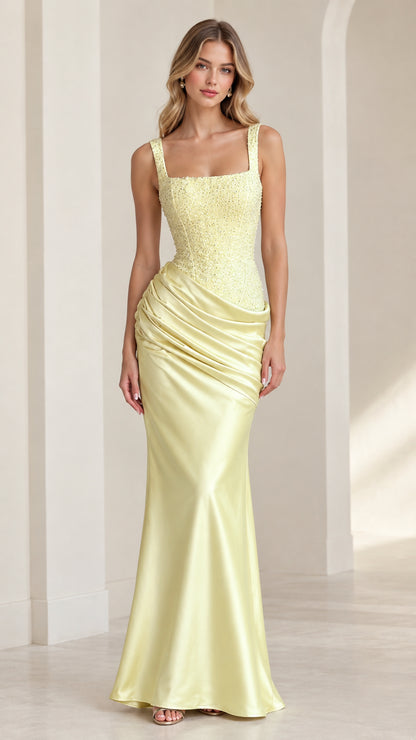 Full front view of model in pastel yellow square neck sequin bodice satin maxi gown