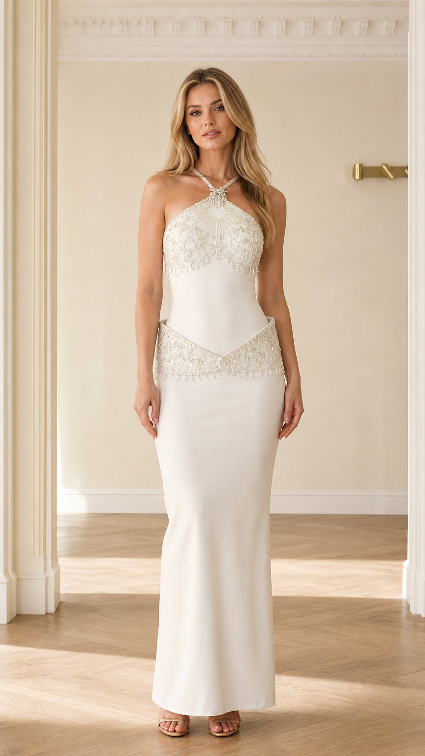 Front full-length view of white beaded halter neck drop waist maxi evening gown