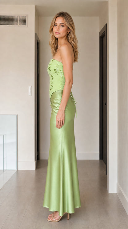 Side profile view of woman wearing sage green corset satin formal gown