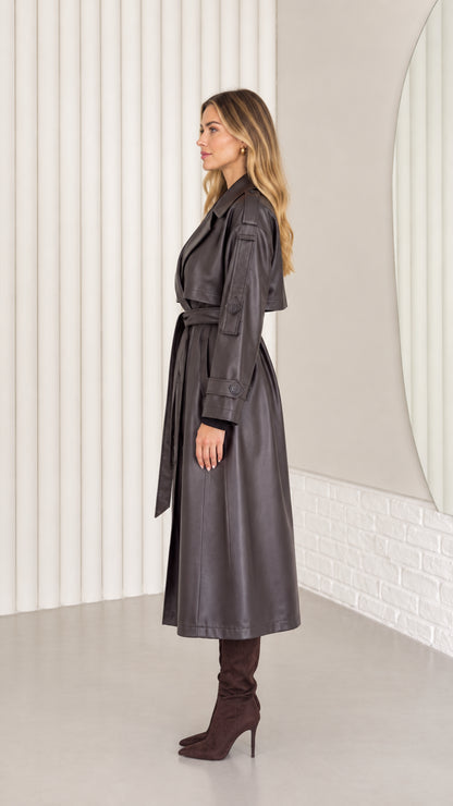 Side profile view of dark brown faux leather long trench coat with waist tie