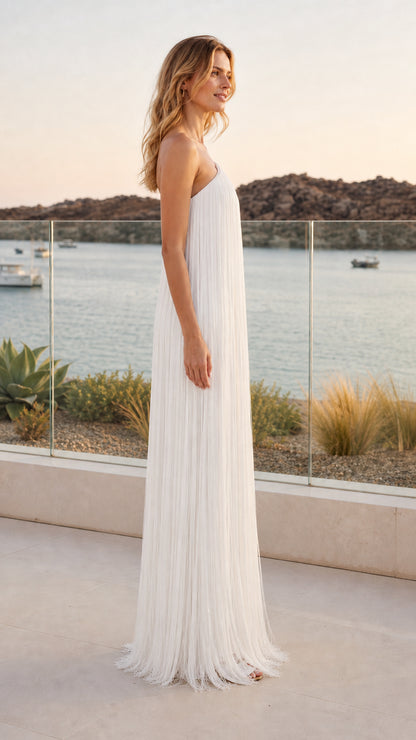 Side profile of model in white pleated column evening gown