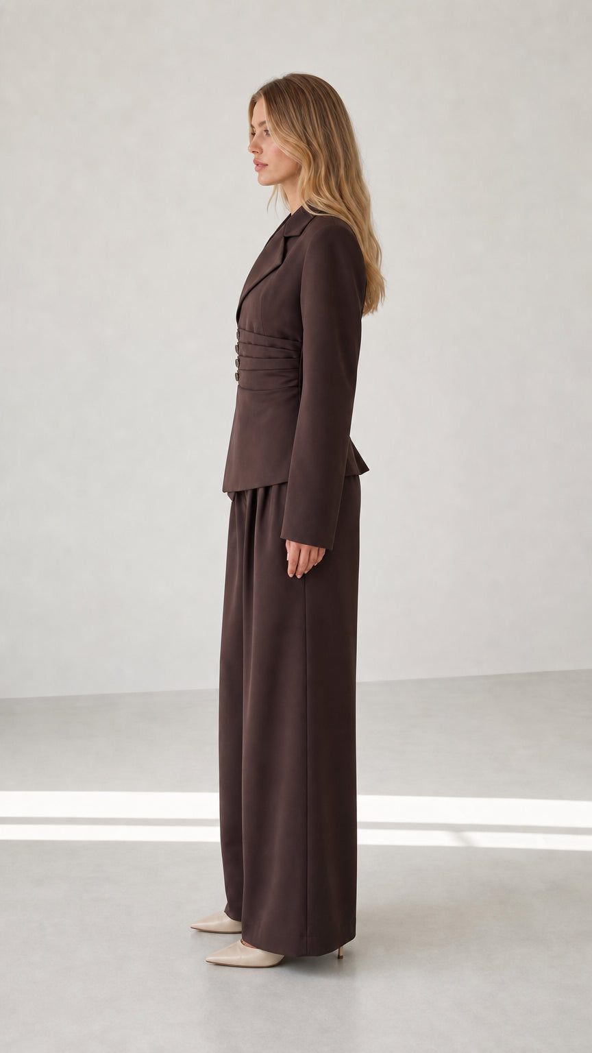 Side profile view of chocolate brown tailored two-piece suit set
