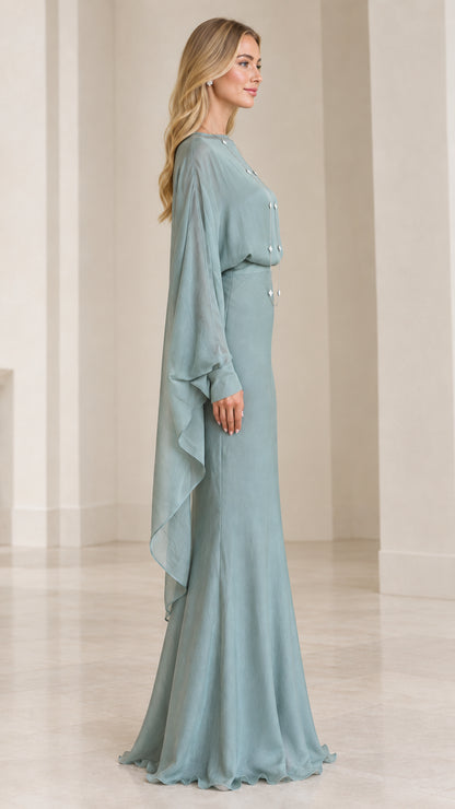 Side profile of model in sage green formal gown with long flowing cape sleeves
