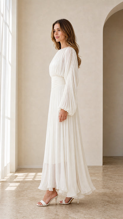 Side view of model in white pleated bishop sleeve gown