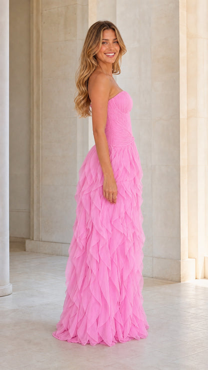Side profile of model in pink strapless evening gown