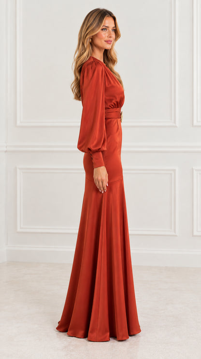 Side profile of model in rust orange satin floor-length evening dress