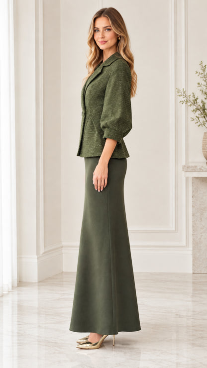Side profile view of woman wearing olive green peplum jacket and maxi skirt