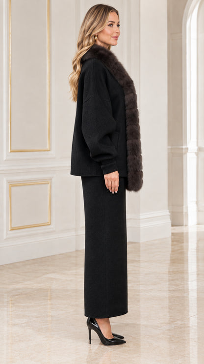 Side profile view of black two-piece cardigan and long skirt outfit