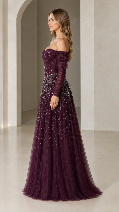 Side view of woman wearing plum beaded tulle formal gown with floral sleeves