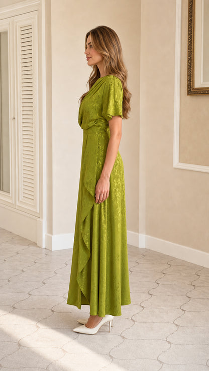 Side profile view of green draped maxi dress