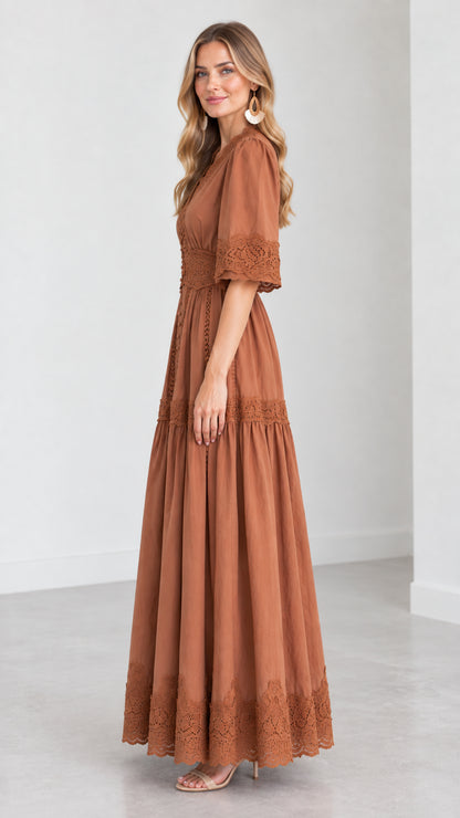 Side profile view of woman wearing a rust brown tiered maxi dress with half sleeves