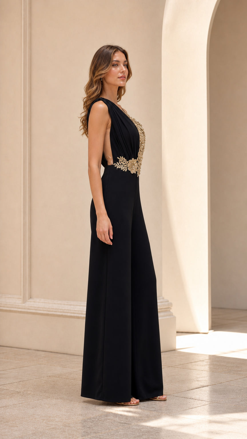 Side profile of model in black formal palazzo jumpsuit with gold floral embroidery