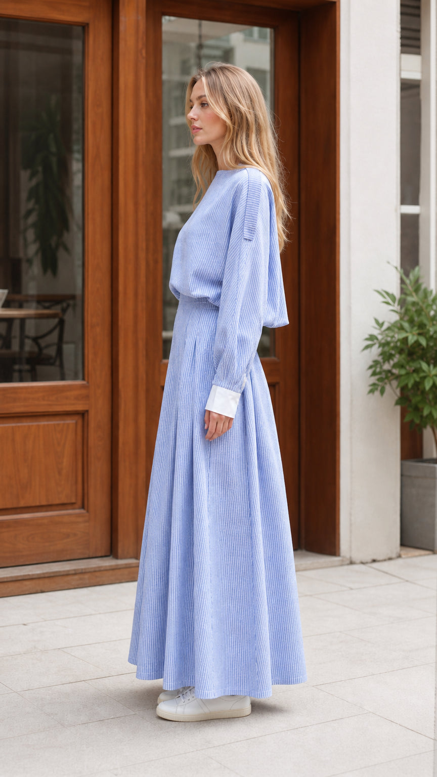 Side profile view of light blue striped maxi dress with pleated skirt