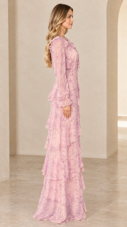 Side view of model showing the flowing silhouette of the blush pink floral maxi dress