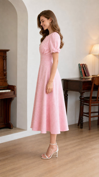 Side profile of woman wearing light pink puff sleeve midi dress with cinched waist