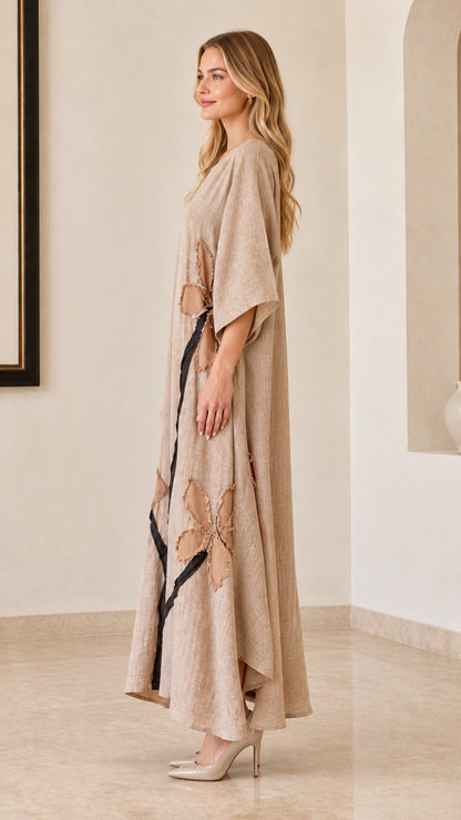 Side profile of woman in beige linen-look maxi dress showing loose fit