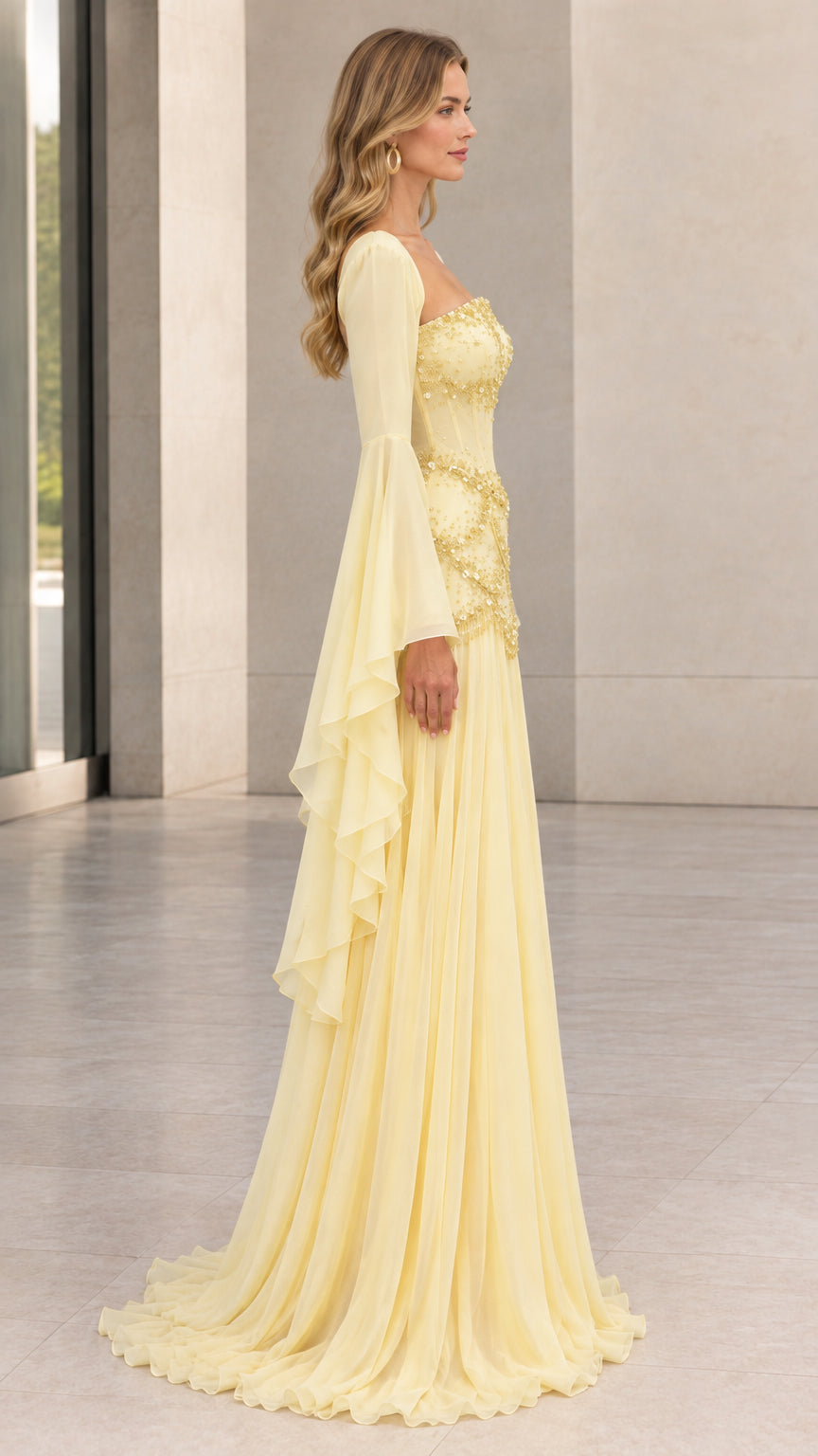 Side view of pastel yellow formal gown showing cascading sleeve drape and floor-length silhouette