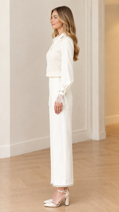 Side profile view of women's white formal lace top and tailored trousers