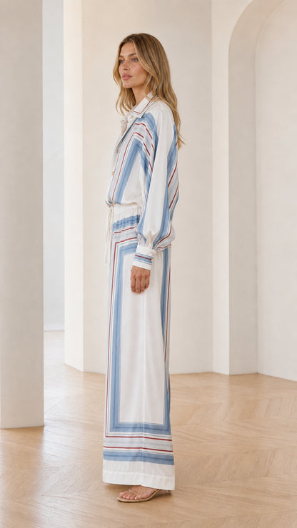 Side profile of model wearing white geometric striped outfit