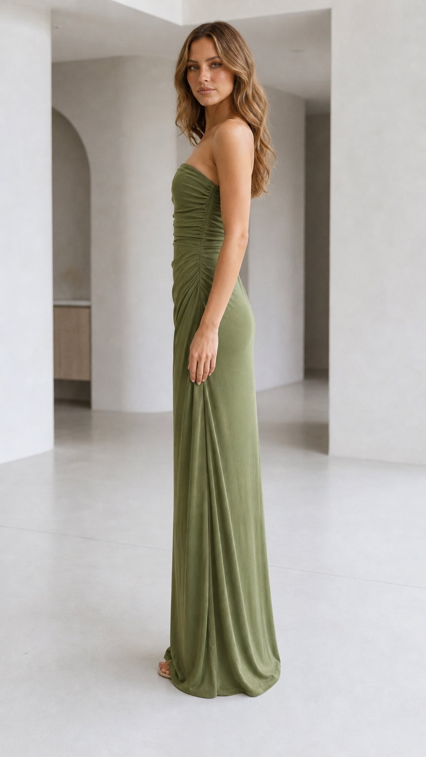 Side profile view of strapless olive green column maxi dress