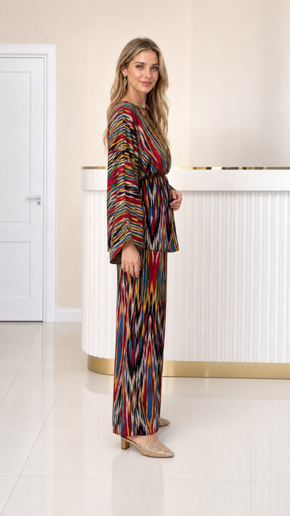 Side profile view of woman wearing multicolor pleated co-ord pants set