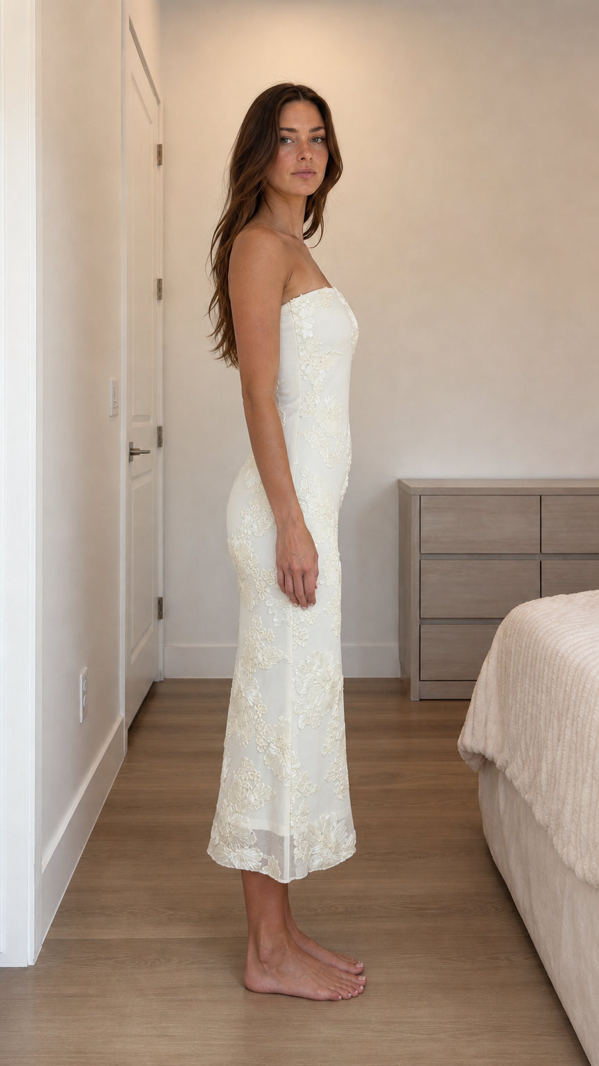 Side profile view of ivory strapless dress