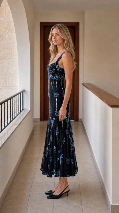 Side profile view of black embroidered midi dress