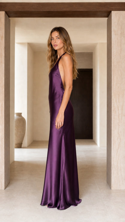 Side profile view of plum purple satin halter evening slip gown